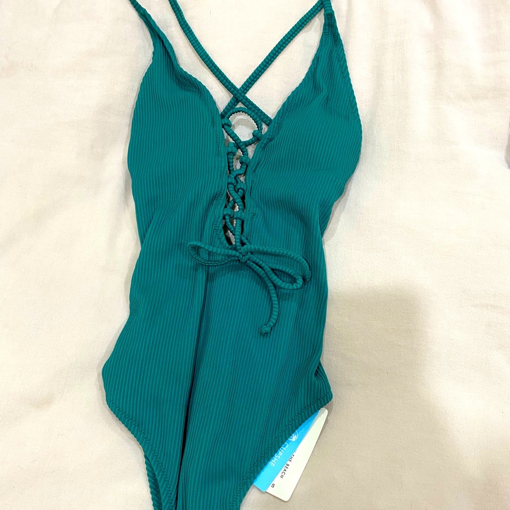 Teal colored, criss-cross styled, one piece bathing suit